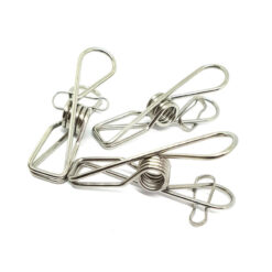 Three plastic-free stainless steel clothes pegs showing the coiled spring and wire grip design