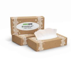 Green Cane facial tissues in cardboard boxes with one tissue pulled out on a plain background