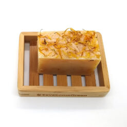 Save Some Green bamboo soap rack holding a handmade soap bar to keep soap dry between uses