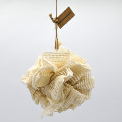 Cream ramie bath puff hanging from a cord with Save Some Green tag on a white background