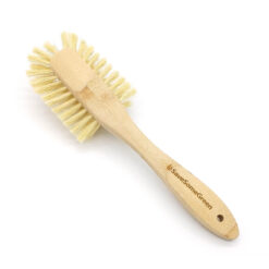 Bamboo and sisal fan brush with light bristles and long bamboo handle on a white background