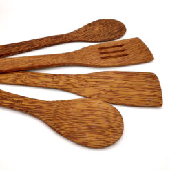 Coconut wood cooking utensils set showing natural grain plastic-free kitchen tools