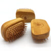 Three chunky bamboo hair brushes with bamboo pins shown on a white background
