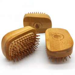 Three chunky bamboo hair brushes with bamboo pins shown on a white background