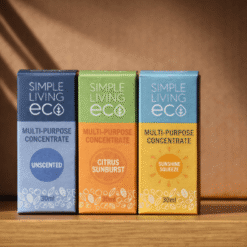 Three boxes of "Simple Living Eco" multi-purpose concentrate on a wooden shelf. Colors: blue (unscented), green (citrus sunburst), yellow (sunshine squeeze).