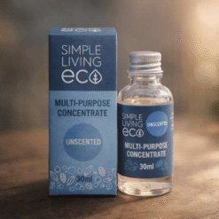 A 30ml bottle and box of Simple Living Eco Multi-Purpose Concentrate in Unscented are displayed on a wooden surface with a blurred green background.