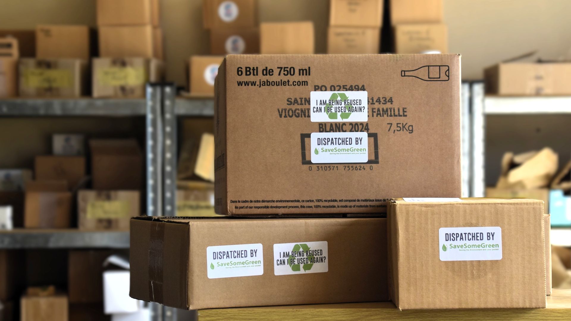 Image of boxes labeled: 'dispatched by Save Some Green' and 'I am being re-used'