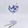 Stainless steel gin straw in a floral gin glass